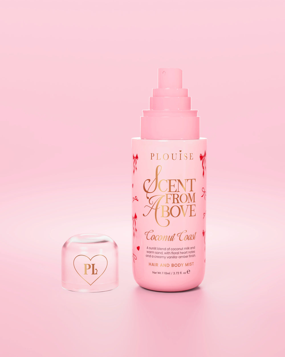 Roze flesje 'Scent from Above' haar- en bodymist met rode strikjes op het flesje en de dop eraf