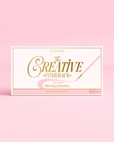 Framsidan av en stängd P.Louise Creative Comeback XXXL Rainbow Eyeshadow Palette med guldtypografi på ett rosa fodral mot en rosa bakgrund