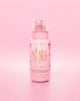 Flacone rosa di profumo per capelli e corpo Scent From Above con disegni di fiocchi rossi su sfondo rosa