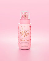 Bottiglia rosa di spray per capelli e corpo "Scent From Above" con grafica a fiocco rosso su sfondo rosa