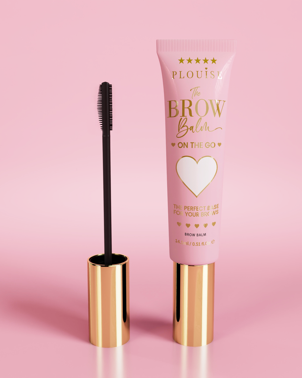 Produs P.Louise Fluffy Soap Brow Balm Instant Fix într-un tub roz cu capac auriu, însoțit de o perie neagră pentru sprâncene, afișată pe un fundal roz.