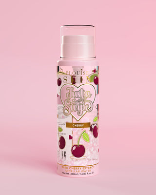 A bottle of P.Louise Just A Swipe Cherry Scented Micellar Water with a pink label featuring cherry illustrations on a pink background