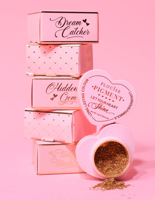 A collection of P.Louise loose pigments in various shades with heart-shaped containers.